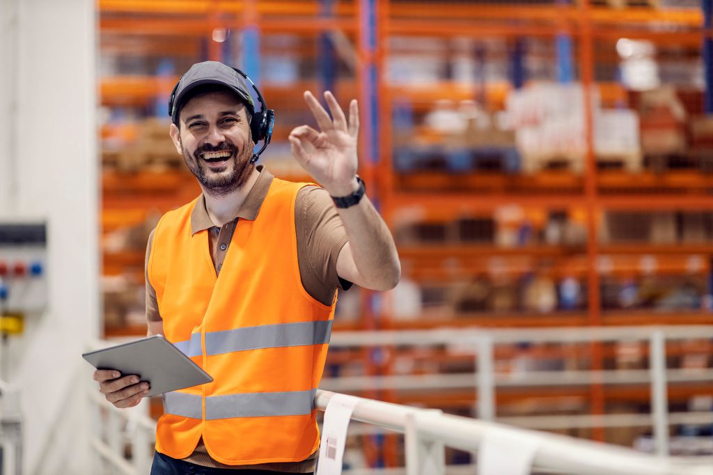 A happy warehouse worker with a headset